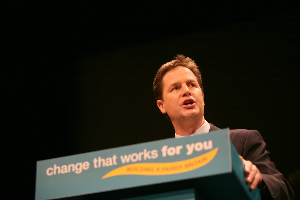 Nick Clegg, leader of Liberal Democrats, speaking to an audience with slogan 'Change that works for you'